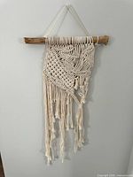 Full view of macrame wall hanging against light wall