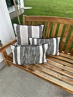 All three cushions on wooden bench
