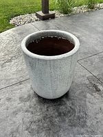 Cylindrical glazed concrete planter exterior view