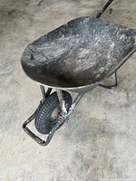 Angled view showing interior of steel tray, frame, and tire