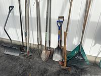 All tools leaning against wall showing full view