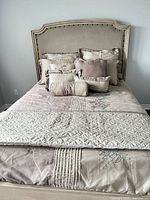 Full bed view showing comforter, coverlet, shams, decorative pillows and bedskirt