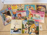 Group of Disney hardcovers, activity pad, puzzle box, showing titles and condition