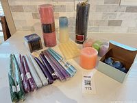 Entire assortment of pillar, taper, votive and tealight candles displayed on countertop