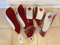 All six headcovers laid out, showing two styles and maple leaf motif