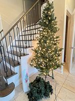 Assembled 6 ft+ pre-lit tree on stand, boxed 3 ft tree, loose garland visible