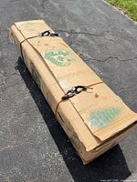 Closed cardboard box labeled Cullen Classic tree, straps applied