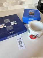 two blue Gourmet Village Bistro boxes and botanical print crock