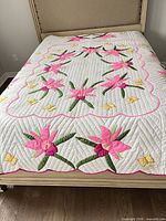 Full view of quilt on queen bed showing overall design and colors