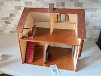 Open-back view showing two stories, staircase, roof access