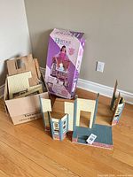 Box, partially assembled wall sections, loose panels