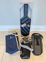 All four items arranged: Hillebrand tote, Legacy insulated tote, mesh carrier, packaged wall-mount rack