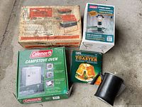 Four boxed camping items and enamel coffee pot