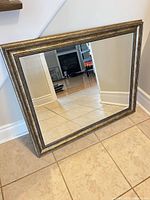 Front view of rectangular mirror leaning against wall