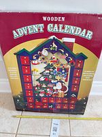 Front of boxed wooden advent calendar showing design, size and features
