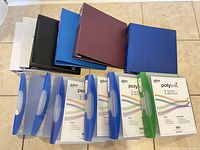 Group of all 11 binders laid out showing colours and types