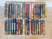 Row of 37 VHS spines showing Disney titles and clamshell cases