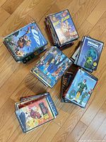 Stacked view of mixed family DVDs and Blu-rays including Up, Home on the Range, Monsters vs Aliens, Elf and others