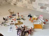 Full lot overview on countertop showing all furniture, dolls and accessories