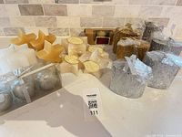 Entire lot of assorted candles displayed on countertop