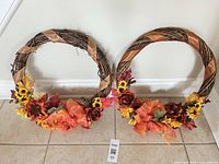 Front view of both wreaths side by side on floor