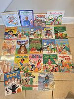 Group shot of all 23 Robert Munsch books laid out on floor