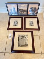 Group view: three-panel frame with colour prints, two square frames with tram images, and one larger portrait frame