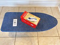 Top view of ironing board and boxed travel iron