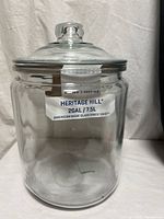 Front view of the clear glass jar with lid and factory label