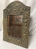 Front view showing embossed brass detail and glass opening