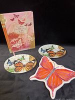 All items grouped: journal, two round dishes, one butterfly-shaped dish