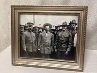 Entire framed photograph, front view showing image and frame details