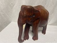 Full view wooden elephant figurine profile