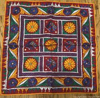 Full view of square embroidered wall hanging