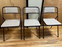 Front view of all three folding chairs showing design and matching upholstery