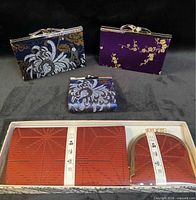 Group of five silk brocade purses and wallet set including boxed red items and three unboxed pieces