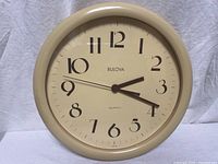Full view of Bulova beige wall clock front