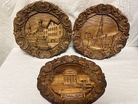 All three carved wood plates front view
