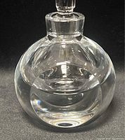 Front view of spherical crystal perfume bottle