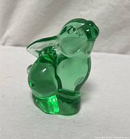 Front view of emerald green glass rabbit paperweight showing overall form and color