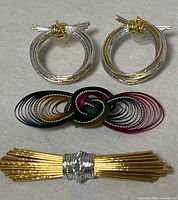 front view of earrings and both brooches