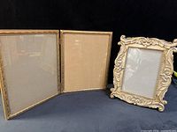 Front view showing hinged double frame and ornate single frame