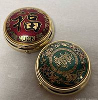 Both trinket boxes closed, showing lid designs
