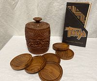 Full view of carved teak holder, six coasters and Tonga Room menu