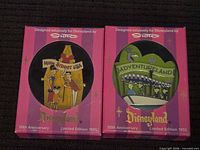 Both boxed Disneyland pins side by side