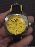 Front view showing yellow dial, trefoil logo, numeral 3, date window