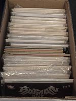 Box containing numerous bagged single-issue comics