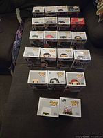 Group shot of all boxed figures displayed on sofa