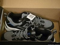 Pair of Fila Envizion sneakers in box, tags visible