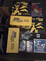 Overview of Forbidden Light boxes, guides, sleeves, dice, bulk cards, and Alpha Sapphire game